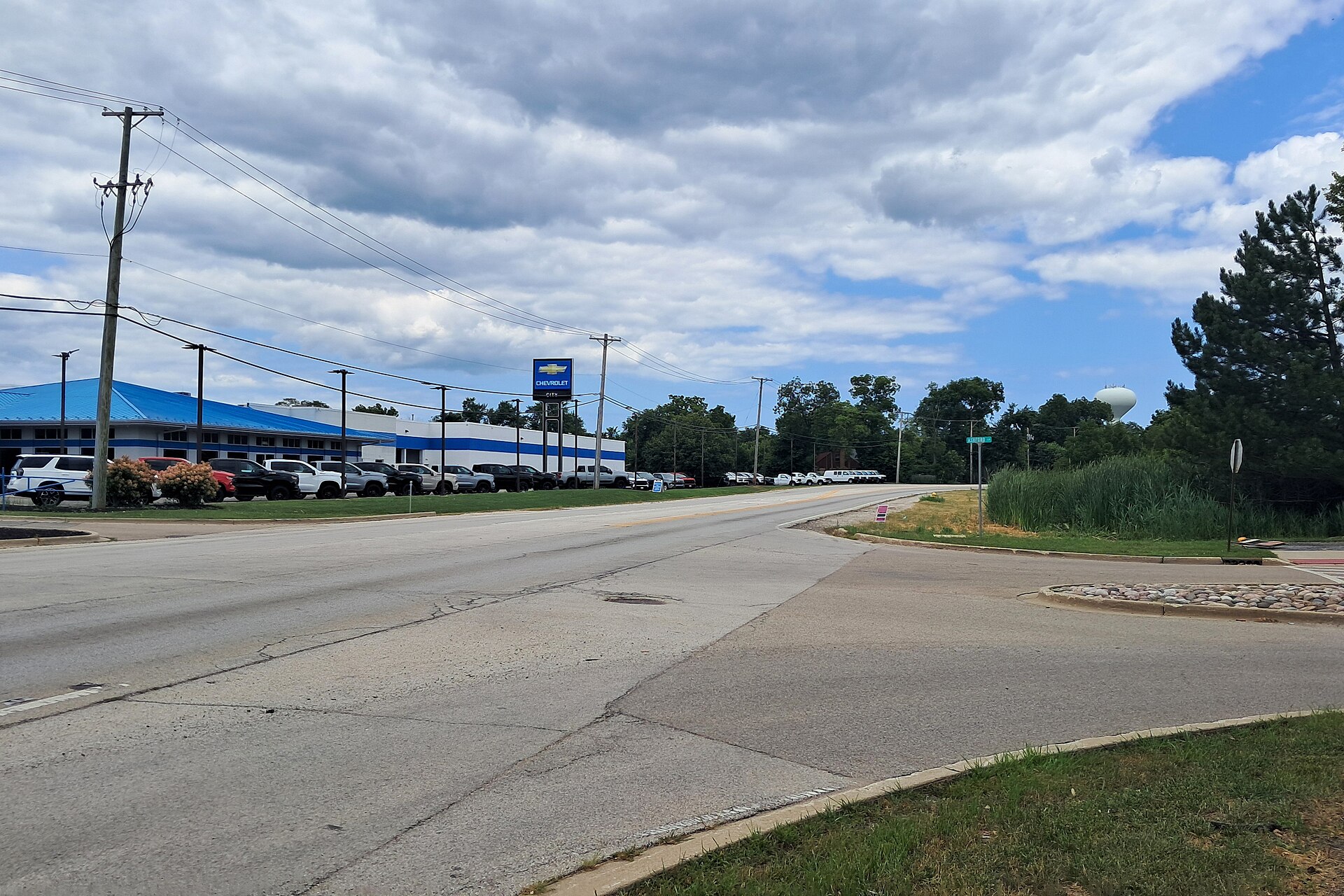 Route 120 heading east at Ashford Lane in Grayslake: a two-lane highway with a turn lane, grass shoulders and a traffic signal